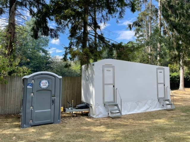 Portable toilet next to luxury portable toilet