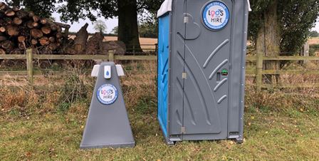 hand wash station next to portable toilet 